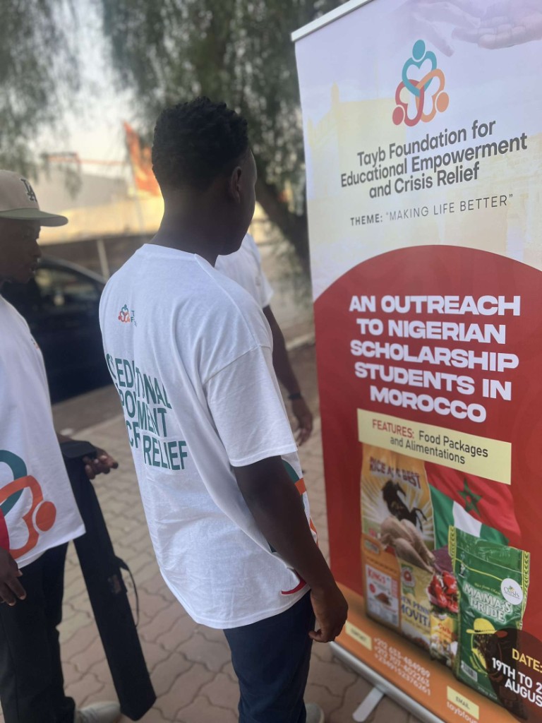 Tayb Foundation Morocco outreach — Volunteers standing with the outreach banner and donated supplies